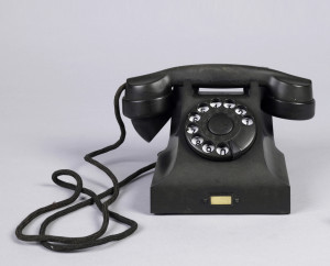 This is a Telephone. It was designed by Johan Christian Bjerknes and Jean Heiberg and made for Norsk Elektrisk Bureau. It is dated 1931. Its medium is bakelite.