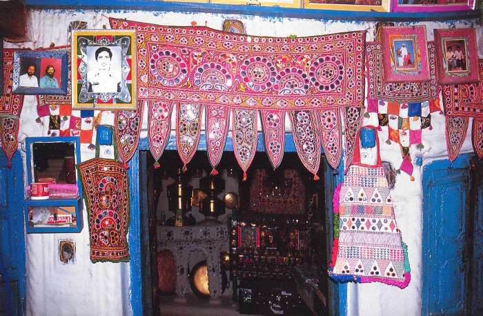 Mirrorwork torans decorating the inner doorway to an Ahir herding caste home, Ratnal village, Kutch. Image: Peter Ackroyd from John Gillow's Traditional Indian Textiles, (London: Thames & Hudson, 1991), 76.