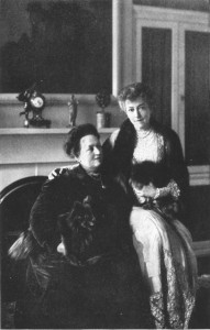 photograph of two women sitting in front of a fireplace