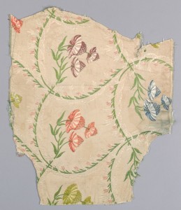 fragment of a textile with a pattern of flowers and leaves