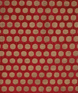 Deep red velvet with offset repeat pattern of gold disks. The foundation is plain weave formed by a red silk warp and tan silk weft; the supplementary warp pile is red silk. The velvet pile is voided in the areas where the coin dots appear, and supplementary gold wefts are floated in pairs to the surface in these areas, bound in twill with the secondary ivory warp.