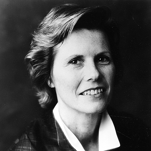 Black-and-white photograph of a smiling woman, pictured shoulders up.