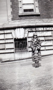 Photograph of Martha "Mattie" Clarke standing outside the mansion's service entrance