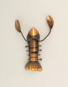 Image features a small copper brooch in the form of a lobster, the patinated surface in tones of bright copper to warm brown. Please scroll down to read the blog post about this object. Please scroll down to read the blog post about this object.