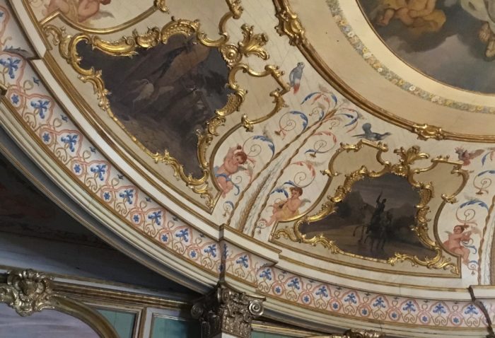 Detail of paintings and panelling within a rococo interior.