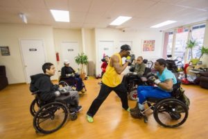 Photograph of a boxing class at the The Axis Project, a multidisciplinary cneter providing fitness and wellness services to people with physical disabilities.