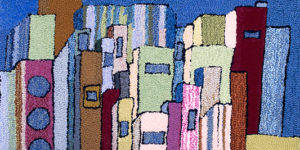 Detail of rug created by Ed Walters, featuring multicolored rectangular blocks.