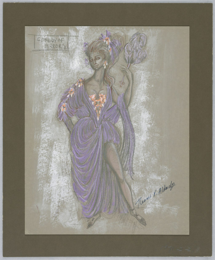 Image features a central woman in a drapey purple dress. Orange and white floral details accent the bodice and her right arm. Her left leg is exposed. Her hair is pulled back in a lively ponytail set with purple, orange, and white florals. She holds feathers in her left hand. Feathery patches of white paint fill the background around the figure.