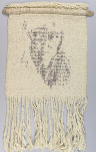 Woven in off-white with the dyed image of a face in grey/pink. Please scroll down to read the blog post about this object.