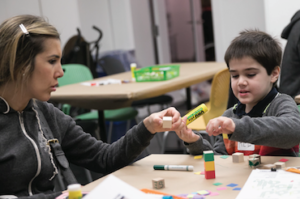 Caregiver and child enjoying design activities during Morning at the Museum, a free program for individuals with cognitive and sensory processing disabilities.