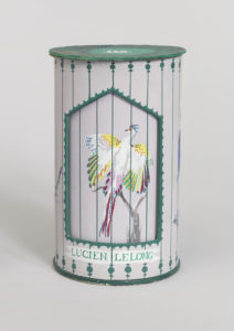 Image features Prototype for a two-part package consisting of cylindrical sleeve (a) over cylindrical box (b), both parts with painted decoration depicting colorful birds in an aviary or bird cage. Please scroll down to read the blog post about this object.