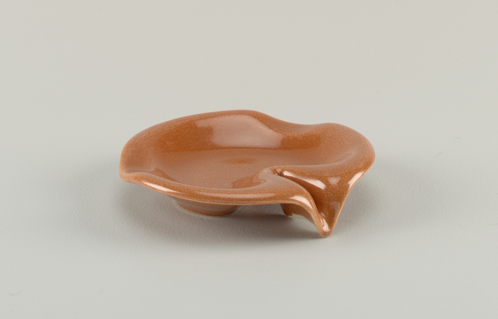 Image features basic circular form with raised shaped rim, indentations in rim; light brown glaze. Please scroll down to read the blog post about this object.