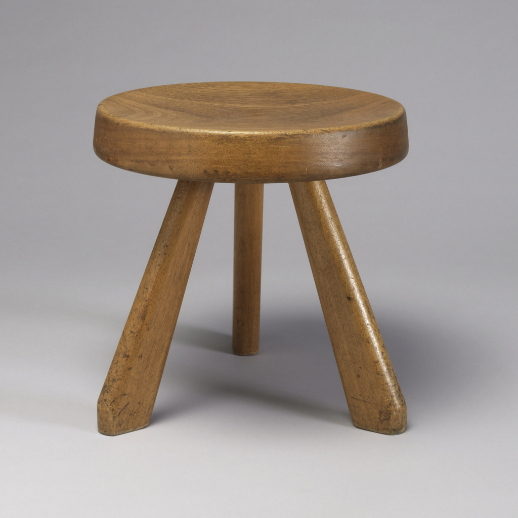 Image features a low wooden stool consisting of a thick circular seat on three splayed, tapering legs, rectangular in section. Please scroll down to read the blog post about this object.