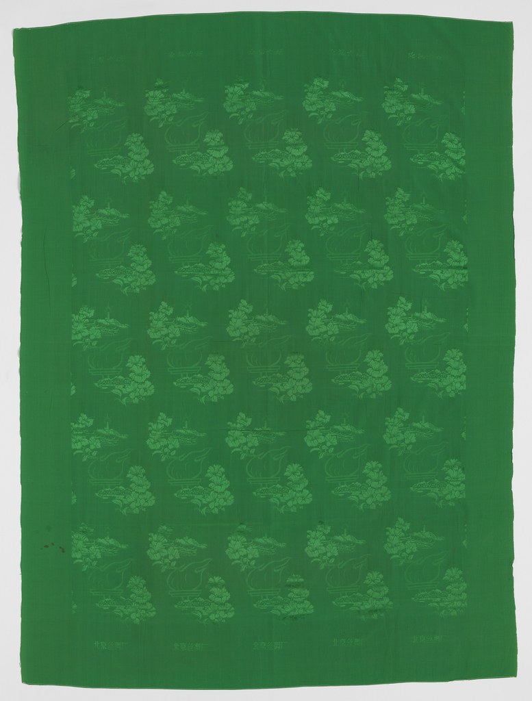 Image features: Bright green synthetic silk quilt cover with a monochrome damask design of a large torch resting on a mountain that represents Yan'an, the northern Shaanxi province town where Mao Zedong and followers regrouped at the end of the Long March. To the right of the torch are two blossoms (possibly hibiscus). The torch motif alternates with mountains topped by the Yan'an pagoda radiating a halo of light. Please scroll down to read the blog post about this object.