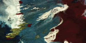 Close up image of textile in navy, white, and a deep red.
