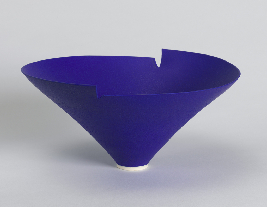Image features bright blue ceramic bowl of inverted conical form with notched rim of opposing heights; narrow circular foot in white. Please scroll down to read the blog post about this object.