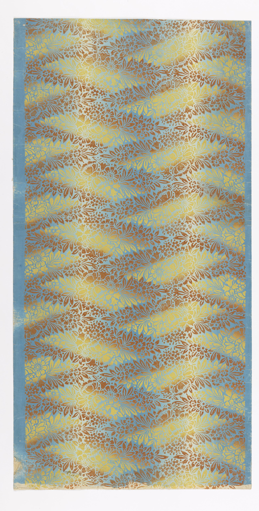 Image shows wallpaper with a geometric pattern printed in an irise or rainbow effect. The printed floral design shades from yellow to brown, the ground color shades from blue to white. Please scroll down to read the blog post about this object.