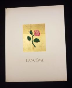 Image features a catalog cover showing a red rose on a gold plated field, above the word LANCÔME in capital letters. Please scroll down to read the blog post about this object.
