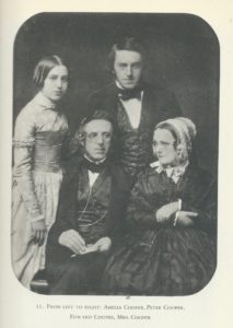 This image is a scan from a book. It pictures a portrait with rounded corners of a family of four—two men and two women, all dress in nineteenth-century attire. The text below the portrait reads "11. From left to right: Amelia Cooper, Peter Cooper, Edward Cooper, Mrs. Cooper".