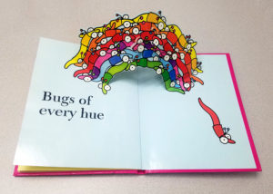 Image features worms rising from the book in various colors. Please scroll down to read the blog post about this object.