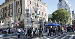 An image of the exterior of Cooper Hewitt, Smithsonian Design Museum with a line of people waiting for entrance during Museum Mile Festival. Scroll down for more information about the Festival, which offers free admission to Cooper Hewitt and 5 more museums on Fifth Avenue.