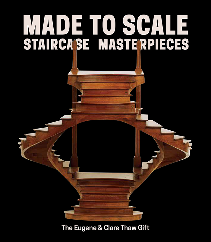 Image is of a cover of a brochure. Set against a black background, a staircase model is the central image. The model is made of a shiny brown wood. It is a double staircase model joining at the top and base with an opening at the center. At the top of the image, words read: "Made to Scale / Staircase Masterpieces"; and at the bottom: "The Eugene & Clare Thaw Gift".