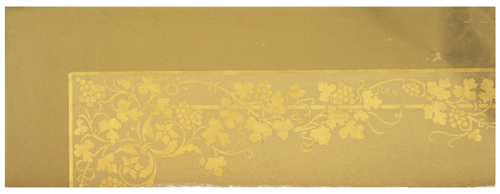 Image is a photograph of a scrap of wallcovering. A horizontal rectangle, the lower right portion of decorated with stenciled gold foliate along a linear path.