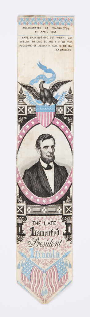 Image features: Bookmark or stevengraph with a portrait medallion of Abraham Lincoln surmounted by an eagle perched on a shield flag that holds a banner in its beak that reads "E Pluribus Unum." Inscription at top reads: "Assassinated at Washington 14 April 1865," and just below another inscription: "I have said nothing but what I am willing to live by. And if it be the pleasure of Almighty God. To die by. (A Lincoln). Please scroll down to read the blog post about this object.