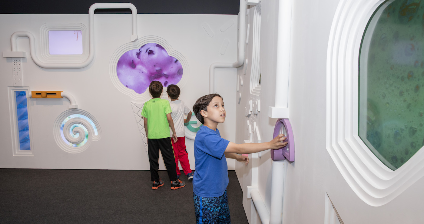 Three boys exploring the Flavor Factory design installation in the exhibition Design Beyond Vision. Scroll down for a family guide to Cooper Hewitt.