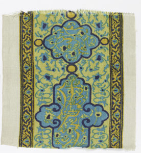 Border design of floral motifs, in style of Hispano-Arabic tile, printed in blues, yellow and orange.