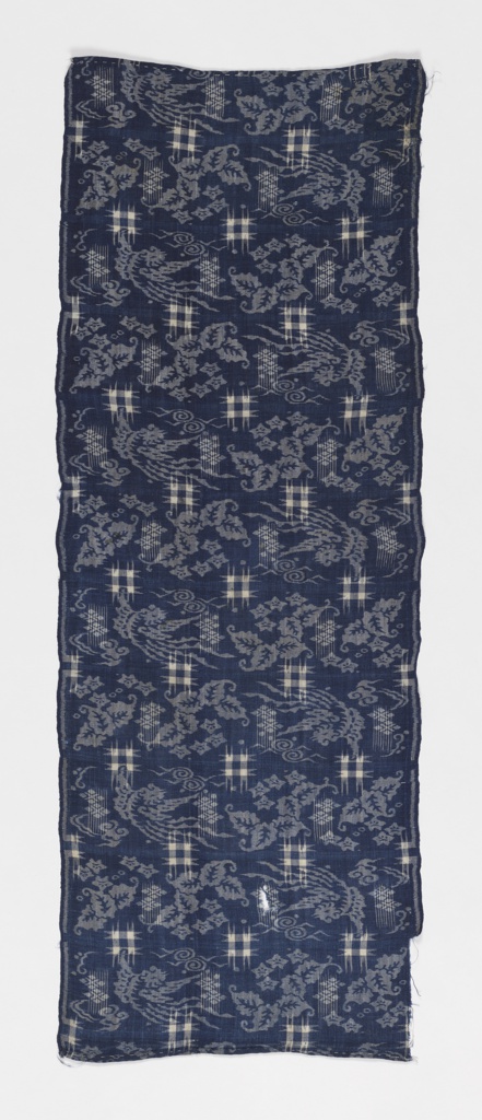 Image features a length of indigo-dyed fabric with scattered designs in white. Scroll down to read the blog about this object.