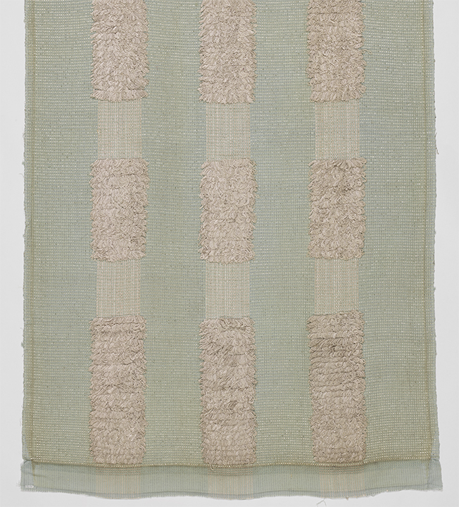 Image features a length of woven fabric with a pale green ground and vertical stripes of silver looped pile. Scroll down to read the blog post about this object.