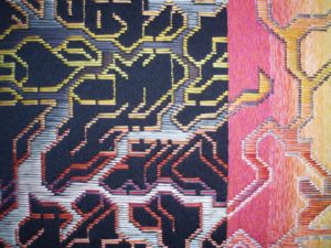 Early woven textile by Patricia Kinsella, multicolored abstract design of branching forms.