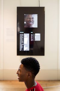 A visitor interacts with R. Luke DuBois' Expression Portrait in Cooper Hewitt's "Face Values" installation at the 2018 London Design Biennale. Photo David Levene.
