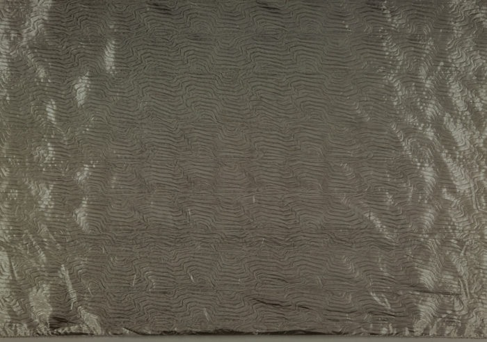 Image features: Yardage of full manufactured width, silver-colored, metallic coated plain woven polyester with wavy linear pattern from the embossing. Please scroll down to read the blog post about this object.