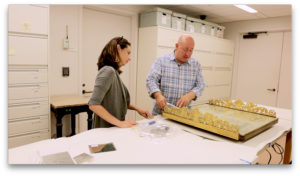 Image of Sarah Barak and Drew Anderson, conservation staff, inspecting the Surtout de Table
