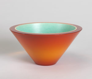 Image features bowl of inverted cone shape, the thick outer wall of polyester resin in tones of orange, bonded to an inner wall of white porcelain, its inner surface glazed turquoise. Please scroll down the read the blog post about this object.