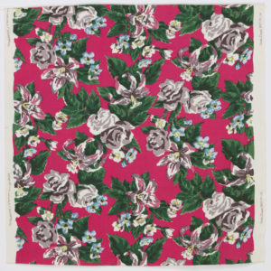 Image features: Printed cotton yard goods sample with six small swatches of other colorways sewn to the back. Hot pink ground with dark green leaves around roses and lilies in shades of blue, yellow-green, and dark brown. Other flowers in pink, off-white, pink-beige and yellow-green. Please scroll down to read the blog post about this object.
