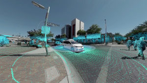 Still from a video picturing a white car radiating dots of blue and green.