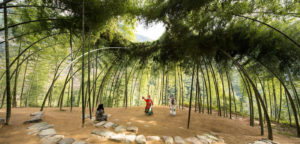 An outdoor performance space is delineated by a canopy of bamboo trees that encircle an earthen stage. The branches meet to form an oculus through which sunlight streams down on the stage.Two men costumed in traditional Asian robes perform for a woman seated on one of several large flat stones that serve as seating. The theater will be included in the museum's upcoming Nature—Cooper Hewitt Design Triennial opening in May. Scroll down for more information about upcoming exhibitions.