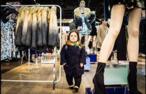 Writer and activist Sinead Burke stands in a department store next to a clothing rack holding fur coats. Because Burke is 3 feet, 5 inches tall, the clothing rack is completely out of her reach. The image was shown during her talk at the World Economic Forum. Click on the link below to watch the video.
