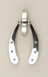 A modern stainless steel brooch in the shape of a wishbone designed by Alessandro Mendini.