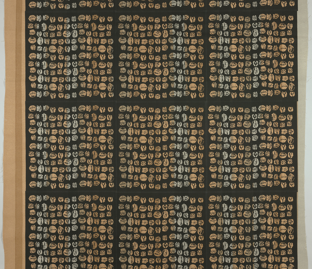 Image features a length of cotton fabric with rows of walnuts in irregular gray to brown multitones arranged in a grid on a black ground. Please scroll down to read the blog post about this object.