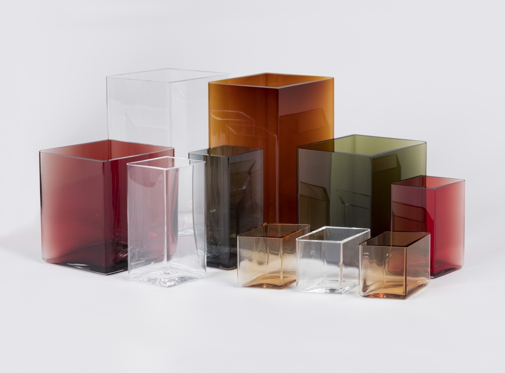 Image features group diamond-shaped glass vases of different heights and colors in overlapping arrangement reminiscent of a cityscape. Please scroll down to read the blog post about this group of objects.