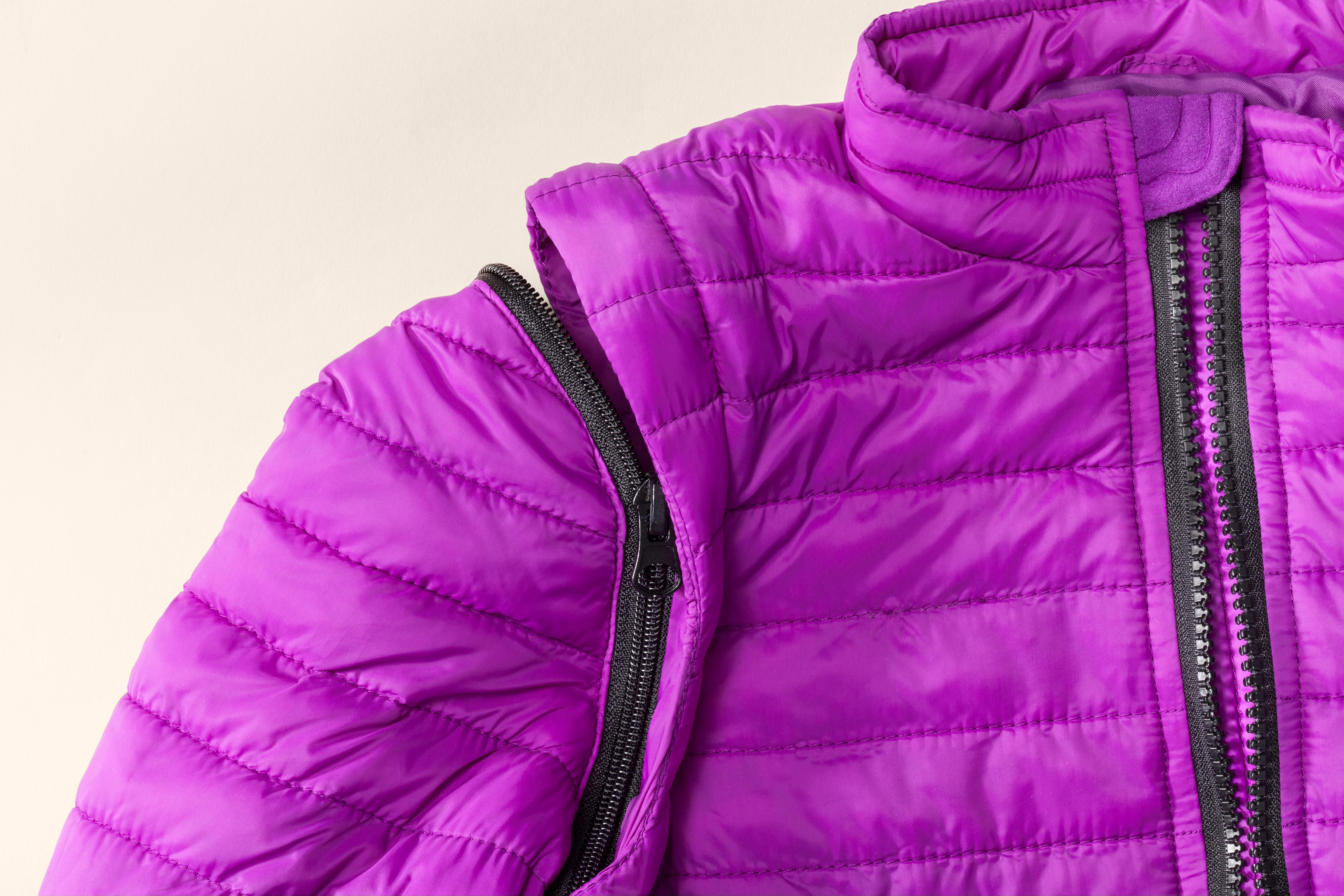 Fashion beyond Function panel. A bright purple child's winter jacket. With velcro sides on a white background.