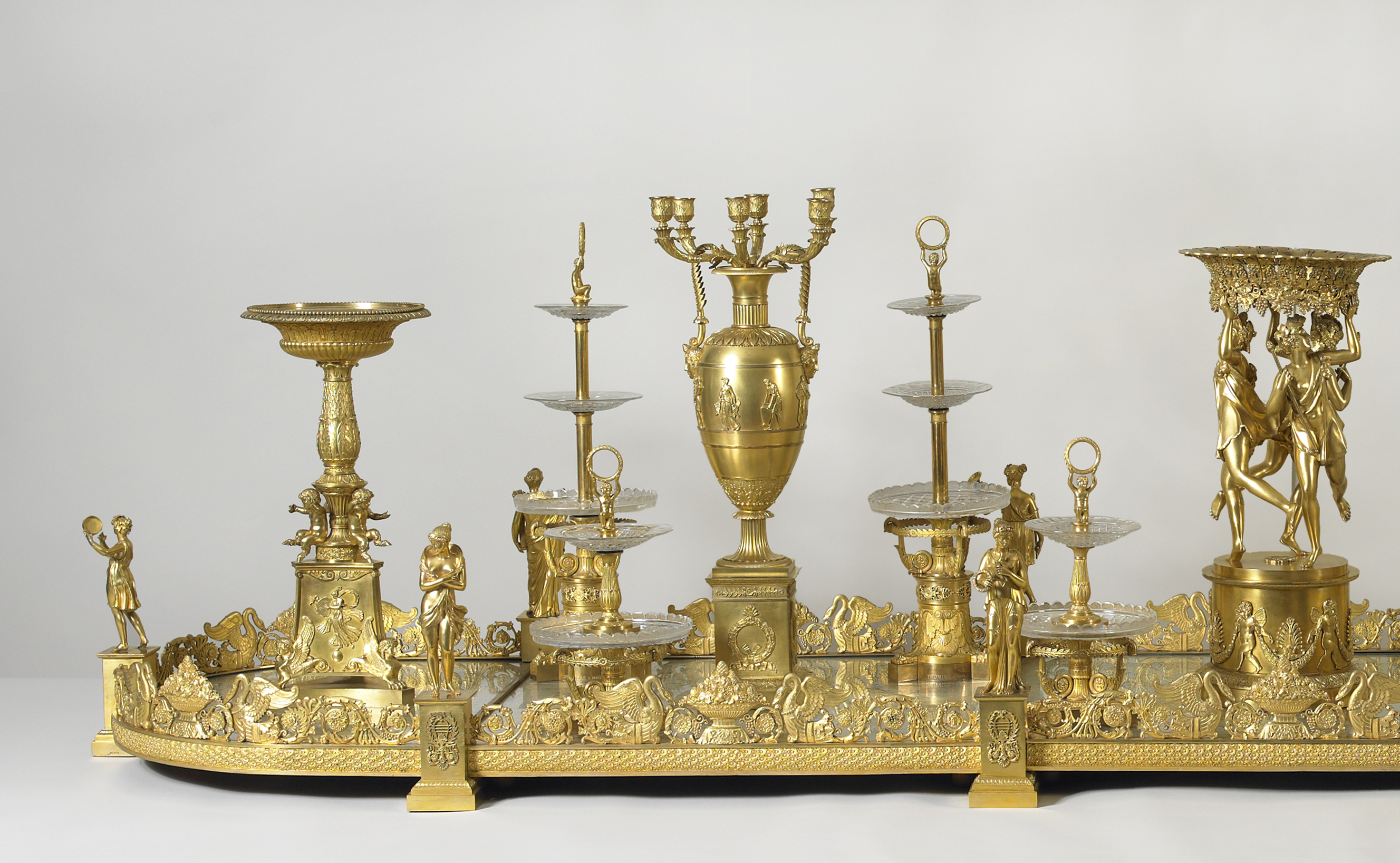 The long gilded surtout de table sits on a white background