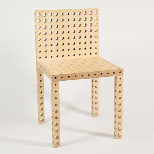 Square chair perforated with a grid of holes of varying sizes sitting on a white background