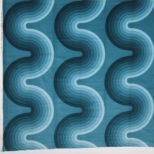 Graphic fabric sample with three thick, wavy bands of turqoise. Each band is a gradient of light to dark