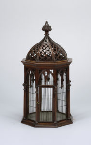 Octagonal wood and wire cage with carved decorative features