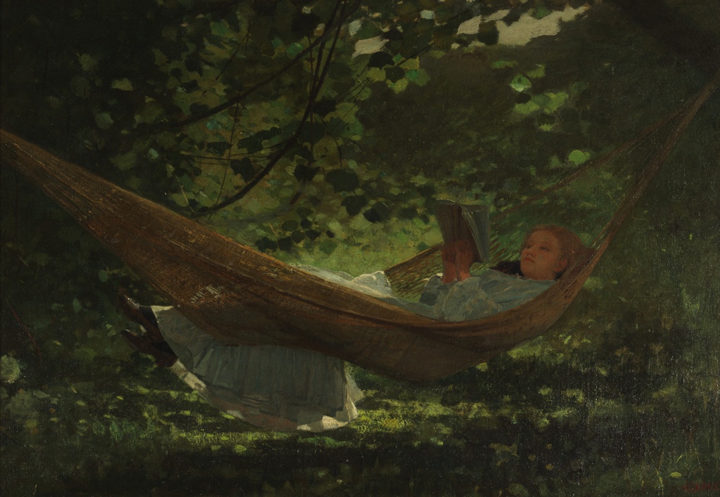 Young woman in a hammock reading